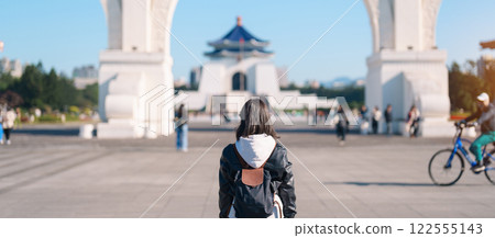 woman traveler visiting in Taiwan, female Tourist sightseeing at National Chiang Kai shek Memorial or Hall Freedom Square, Taipei City. Popular landmark and attractions. Asia Travel concept 122555143