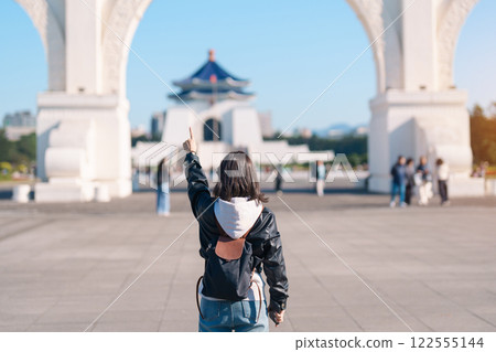 woman traveler visiting in Taiwan, female Tourist sightseeing at National Chiang Kai shek Memorial or Hall Freedom Square, Taipei City. Popular landmark and attractions. Asia Travel concept 122555144