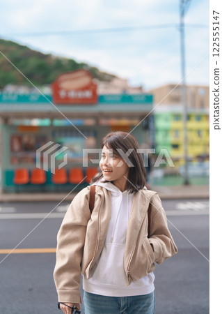 woman traveler visiting in Taiwan, female Tourist with backpack sightseeing at Keelung, Colorful Zhengbin Fishing Port. Popular landmarks and attractions near Taipei City. Asia Travel concept woman traveler visiting in Taiwan, female Tourist with backpack sightseeing at Keelung, Colorful Zhengbin Fishing Port. Popular landmarks and attractions near Taipei City. Asia Travel concept 122555147