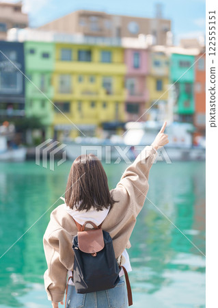 woman traveler visiting in Taiwan, female Tourist with backpack sightseeing at Keelung, Colorful Zhengbin Fishing Port. Popular landmarks and attractions near Taipei City. Asia Travel concept woman traveler visiting in Taiwan, female Tourist with backpack sightseeing at Keelung, Colorful Zhengbin Fishing Port. Popular landmarks and attractions near Taipei City. Asia Travel concept 122555151