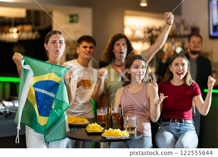 Brazilian fans with the national flag watch match on TV and express various emotions Brazilian fans with the national flag watch match on TV and express various emotions 122555644
