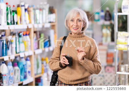 Positive mature woman choosing perfume in department store Positive mature woman choosing perfume in department store 122555660