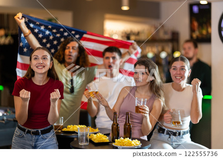Group of fans in bar with US flag 122555736