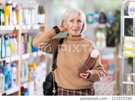 Mature woman choosing hair spray 122555780