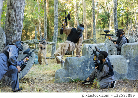Team of paintball players attacks enemy at an army training ground Team of paintball players attacks enemy at an army training ground 122555899