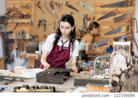 Young girl viewing interestedly taller mold in workshop Young girl viewing interestedly taller mold in workshop 122556006