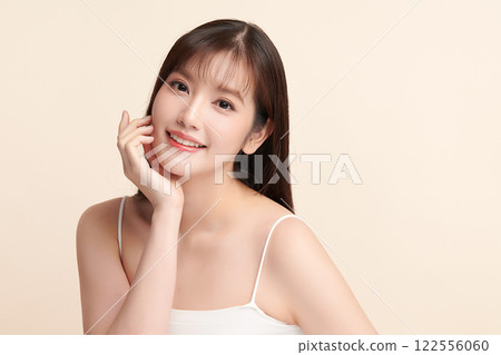 Beautiful young asian woman with clean fresh skin on beige background, Face care, Facial treatment, Cosmetology, beauty and spa, Asian women portrait. Beautiful young asian woman with clean fresh skin on beige background, Face care, Facial treatment, Cosmetology, beauty and spa, Asian women portrait. 122556060