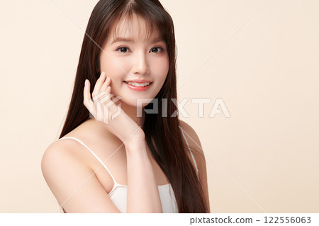 Beautiful young asian woman with clean fresh skin on beige background, Face care, Facial treatment, Cosmetology, beauty and spa, Asian women portrait. Beautiful young asian woman with clean fresh skin on beige background, Face care, Facial treatment, Cosmetology, beauty and spa, Asian women portrait. 122556063