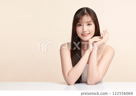 Beautiful young asian woman with clean fresh skin on beige background, Face care, Facial treatment, Cosmetology, beauty and spa, Asian women portrait. Beautiful young asian woman with clean fresh skin on beige background, Face care, Facial treatment, Cosmetology, beauty and spa, Asian women portrait. 122556069
