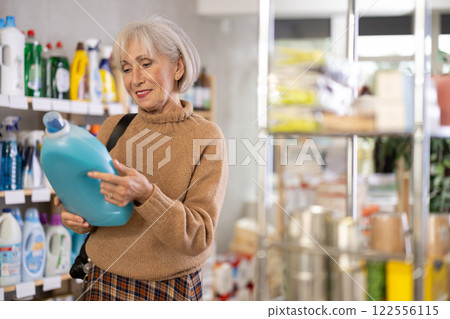 Woman choosing a large fabric softener Woman choosing a large fabric softener 122556115