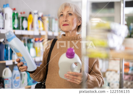 Mature woman choosing laundry detergent in department store 122556135