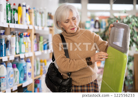 Woman choosing an ironing board Woman choosing an ironing board 122556233