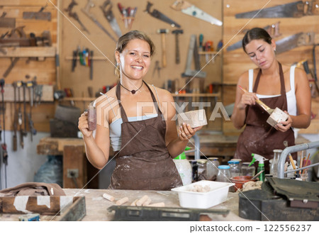 Girl is busy in carpentry workshop Girl is busy in carpentry workshop 122556237