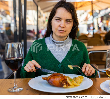 Woman traveler eating fried toston in restaurant of Salamanca Woman traveler eating fried toston in restaurant of Salamanca 122556289