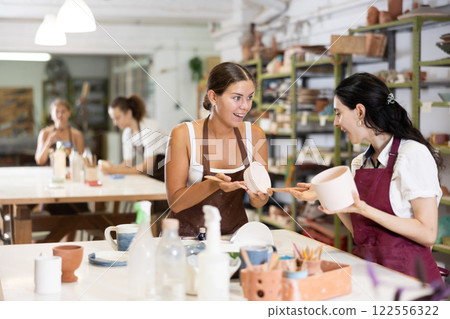 Girl performs polishing of ceramic product 122556322