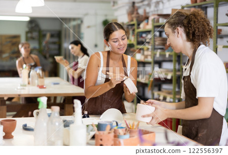 Guy performs polishing of ceramic product 122556397