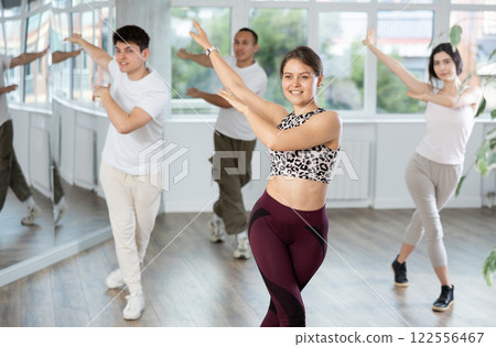 Smiling young people practicing vigorous lindy hop movements in dance class Smiling young people practicing vigorous lindy hop movements in dance class 122556467
