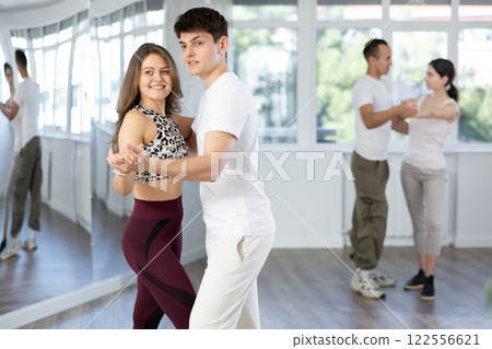 Young couple practicing passionate samba in dance class 122556621