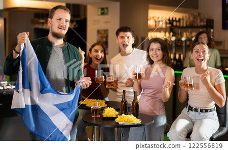 Group of fans in bar with Scottish flag 122556819