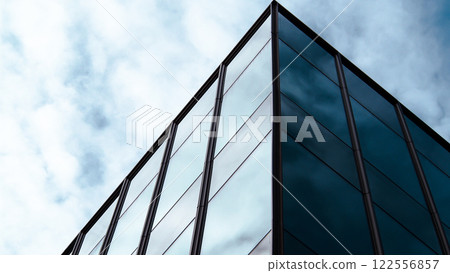 Minimalist Reflection. Sleek Glass Facade with Subtle Sky Reflections, Perfect for Architectural Branding, Urban Aesthetic Studies, or Modern Design Showcases 122556857