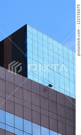 Urban Architectural Elegance. Clean Lines and Reflective Glass Surfaces, Complemented by Minimalist Concrete Patterns. Perfect for Futuristic Cityscape Concepts, Design Visualizations, or Business-Ori 122556879