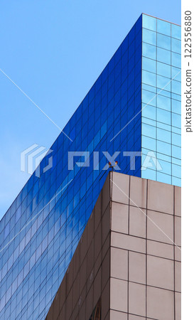 Contemporary Geometry in Architecture. A Striking Interplay of Glass Panels and Concrete Frames, Reflecting a Vibrant Sky. Ideal for Modern Urban Designs, Architectural Publications, or Corporate Aest 122556880
