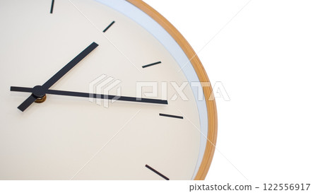 A minimalist wooden-framed clock with clean black hands and markers, set against a simple white background. A minimalist wooden-framed clock with clean black hands and markers, set against a simple white background. 122556917