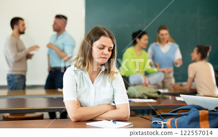 Portrait of a student girl with a pen and a copybook, preparing for classes Portrait of a student girl with a pen and a copybook, preparing for classes 122557014