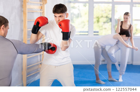 Two men training boxing fight in studio Two men training boxing fight in studio 122557044