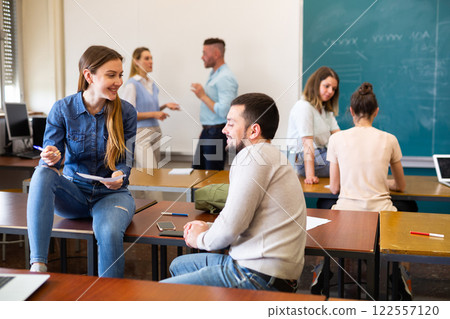 Student girl discusses the questions of the upcoming exam with a fellow student Student girl discusses the questions of the upcoming exam with a fellow student 122557120