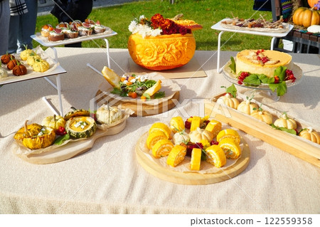 Dessert table on wedding with tasty cakes, cookies and sweets in pastel colors. Professional catering and servings. Festive atmosphere. Dessert table on wedding with tasty cakes, cookies and sweets in pastel colors. Professional catering and servings. Festive atmosphere. 122559358