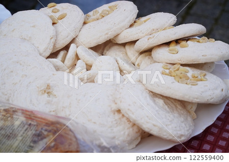 Dessert table on wedding with tasty cakes, cookies and sweets in pastel colors. Professional catering and servings. Festive atmosphere. 122559400