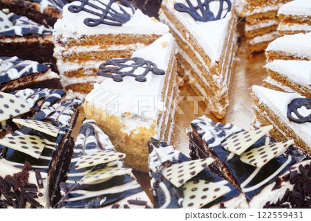 Dessert table on wedding with tasty cakes, cookies and sweets in pastel colors. Professional catering and servings. Festive atmosphere. 122559431