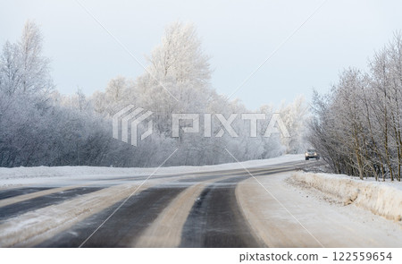 Car road in the snow in frosty winter weather. Car road in the snow in frosty winter weather. 122559654