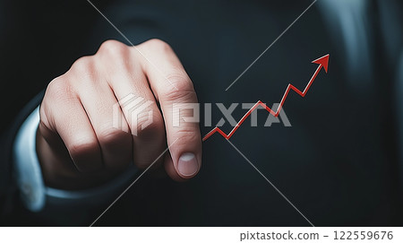 hand in suit points at rising graph, symbolizing growth and success in business. This image conveys strong message of progress and achievement 122559676