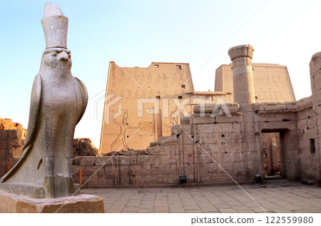 Granite statue of God Horus falcon at entrance Temple of Horus in sunset light, Edfu, Egypt. Famous landmark ptolemaic Horus Temple in Idfu (Edfou, Behdet), Egypt, Africa 122559980