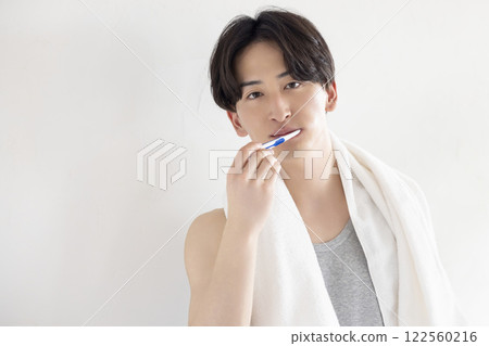 Young man brushing his teeth Young man brushing his teeth 122560216