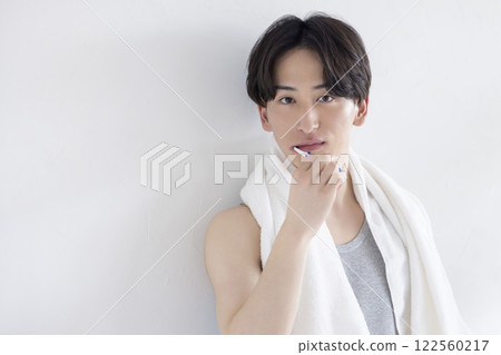 Young man brushing his teeth 122560217