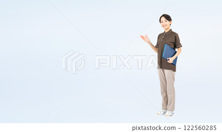 Full-body photo of middle-aged female staff guiding 122560285