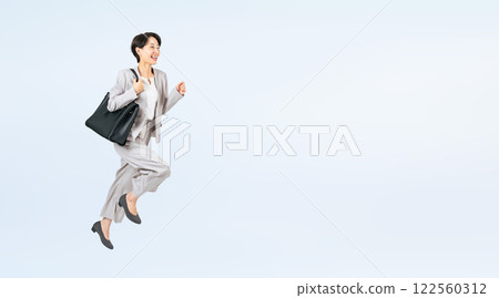 一名中年女商務人士跳躍的全身照片 一名中年女商務人士跳躍的全身照片 122560312