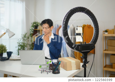 Modern online store owner getting ready for a product showcase using live streaming tools Modern online store owner getting ready for a product showcase using live streaming tools 122560399