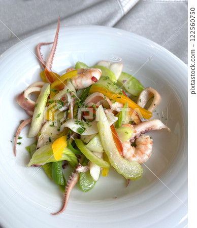 Mix of seafood and vegetables on plate. Asian cuisine. Healthy food and longevity. Mix of seafood and vegetables on plate. Asian cuisine. Healthy food and longevity. 122560750