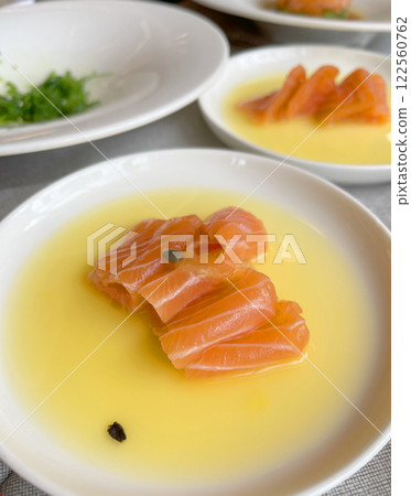 Sashimi in mango juice on plate. Salmon slices. Seafood and Asian cuisine. Healthy foods and longevity. Sashimi in mango juice on plate. Salmon slices. Seafood and Asian cuisine. Healthy foods and longevity. 122560762