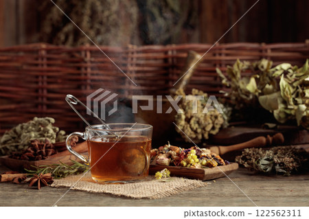 Cup of herbal tea with various dried herbs, flowers, and spices. Cup of herbal tea with various dried herbs, flowers, and spices. 122562311