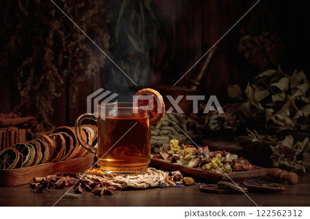 Cup of herbal tea with various dried herbs, flowers, and spices. Cup of herbal tea with various dried herbs, flowers, and spices. 122562312