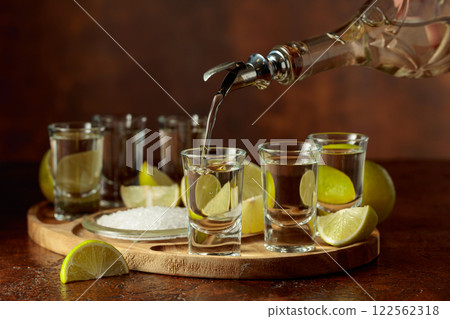Gold tequila with salt and lime slices. 122562318