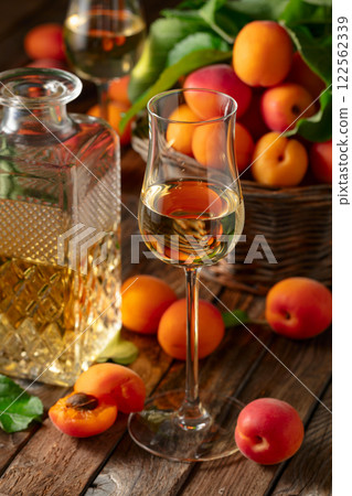 Apricot liqueur or grappa and fresh apricots. Apricot liqueur or grappa and fresh apricots. 122562339