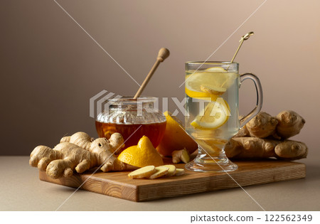 Ginger tea with lemon and honey on a beige background. Ginger tea with lemon and honey on a beige background. 122562349