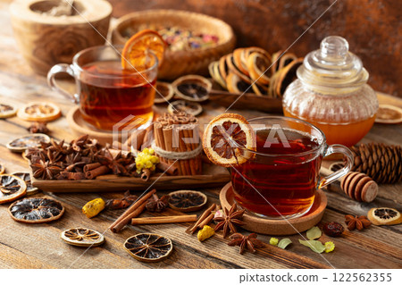 Herbal tea with cinnamon, anise, dried herbs, and dry citrus slices. 122562355