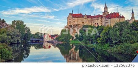 Majestic Sigmaringen Castle reflected in the calm river under a blue sky 122562376
